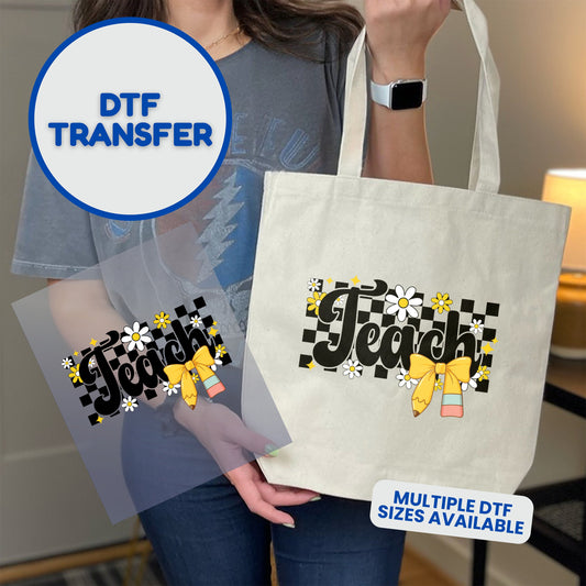 DTF transfer with "Teach!" text, checkered pattern, and yellow bow on a tote bag.