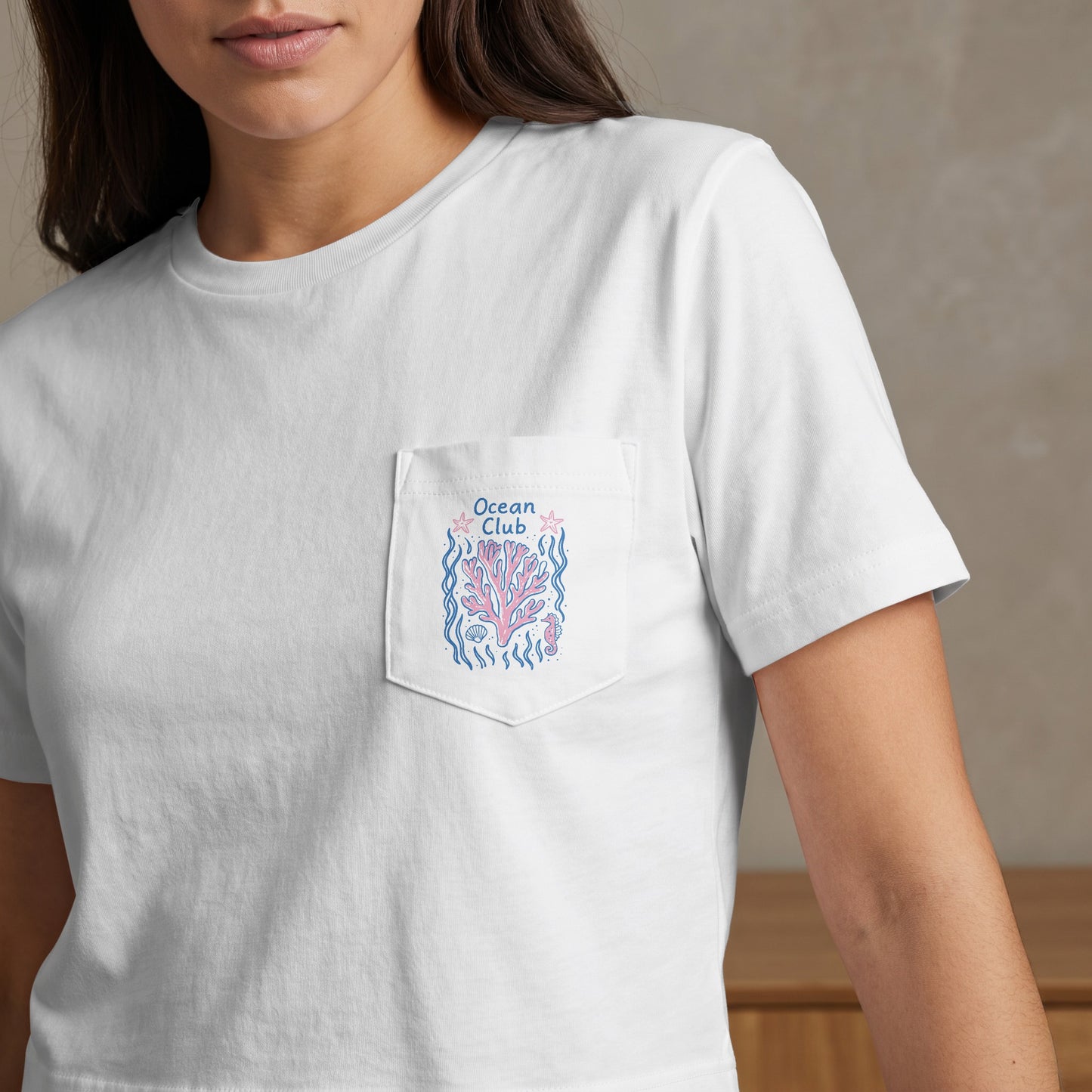 White t-shirt with embroidered coral, starfish, and "Ocean Club" text on pocket.