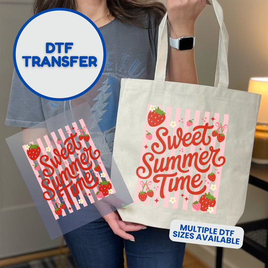 Tote bag with "Sweet Summer Time" DTF transfer featuring strawberries and stripes.