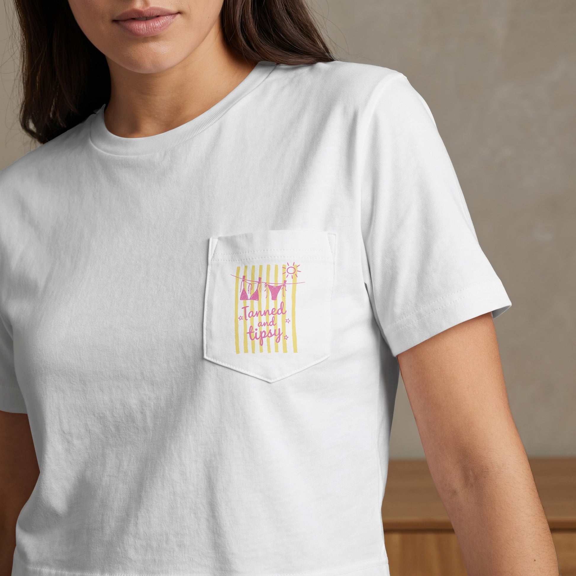 White t-shirt with pink and yellow striped pocket graphic and text.