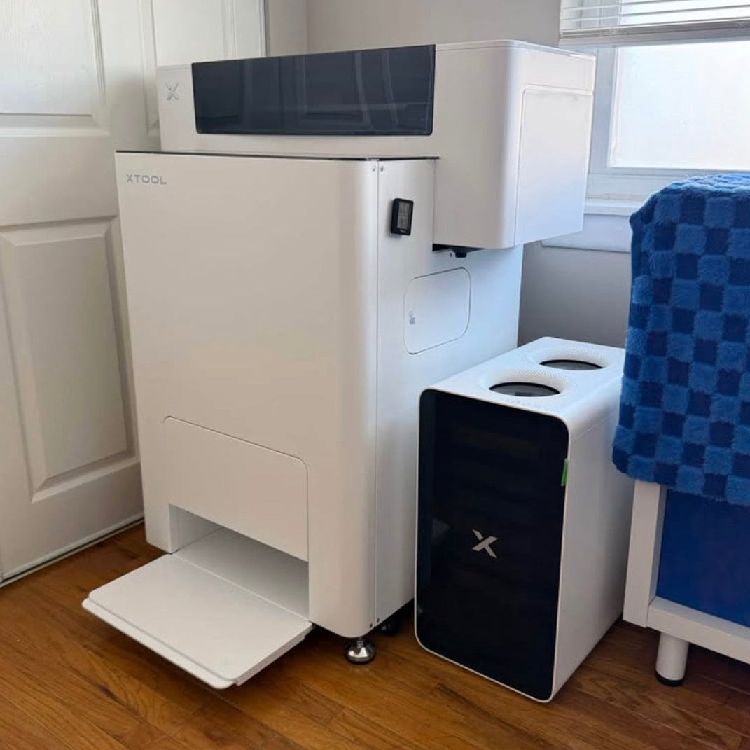 White appliance with a blue towel on a rack in a room with wooden flooring.