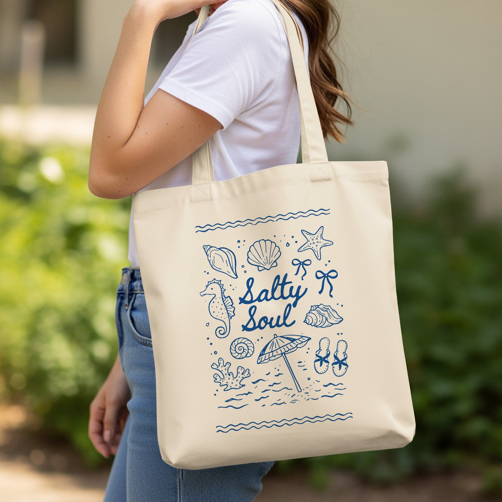 Canvas tote bag with "Salty Soul" and beach-themed illustrations in blue.